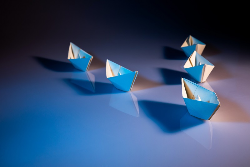 White paper boats on white surface by Kobu Agency